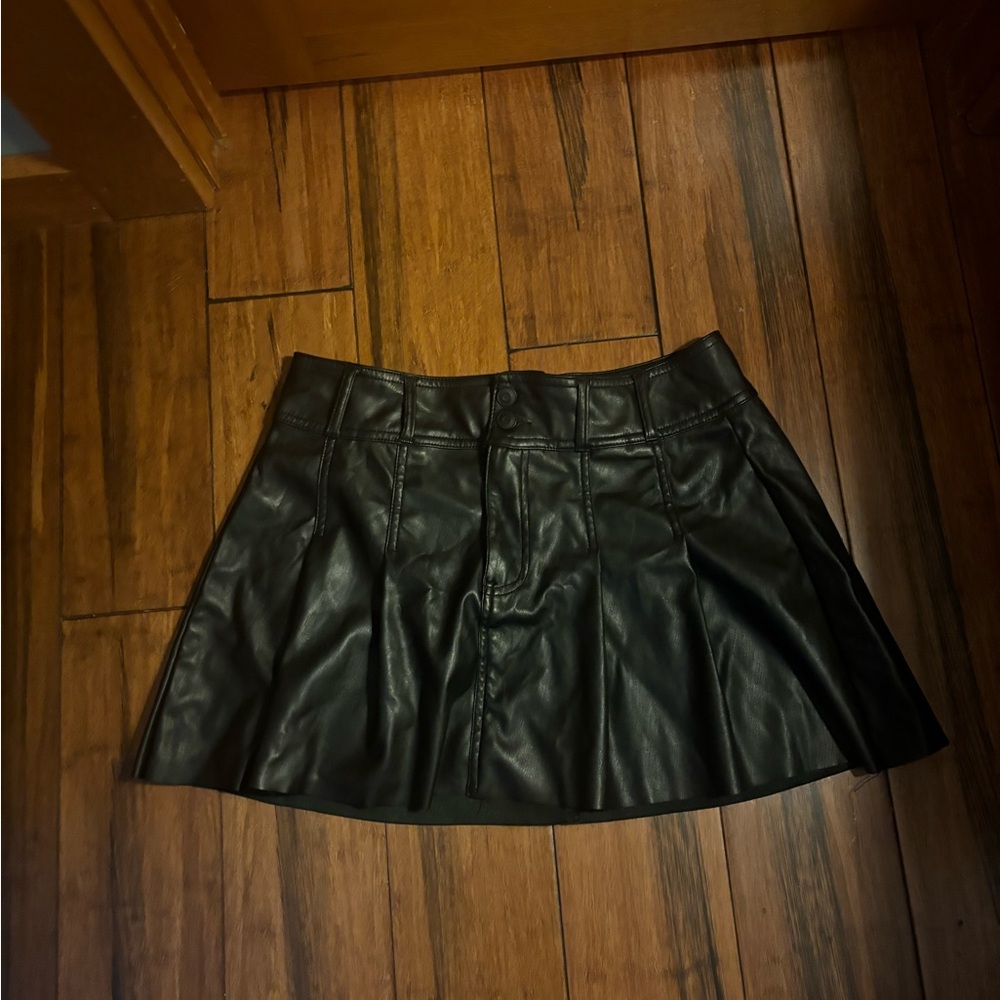 Black leather mini skirt with zipper and button closure